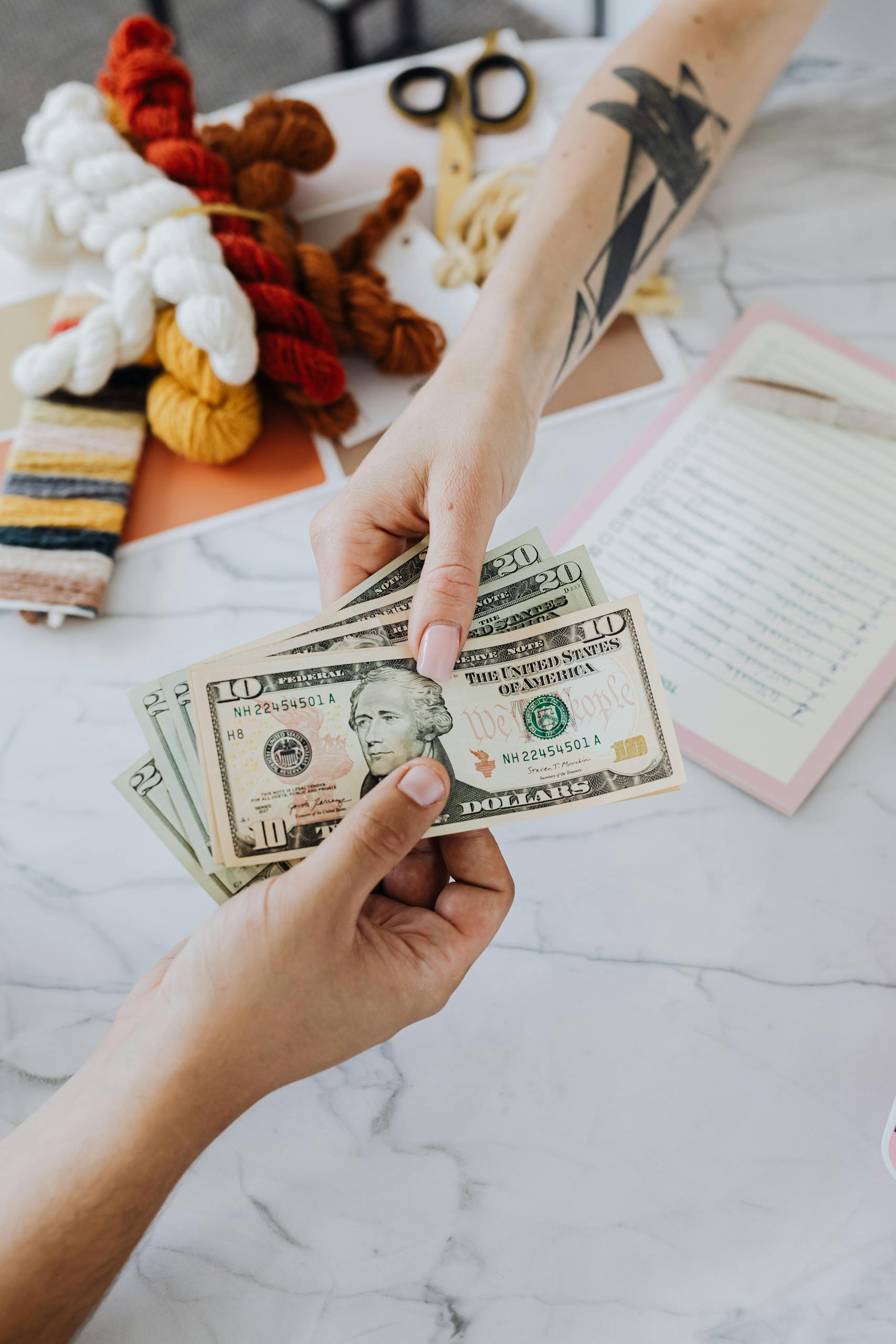 Hands Exchanging Dollars